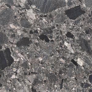 Gray speckled stone surface with dark and light fragments.