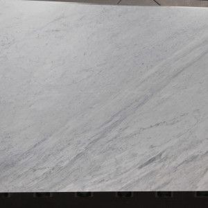 White and gray marble slab with subtle veining.