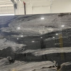 Dark gray and white marble slab with swirling patterns.