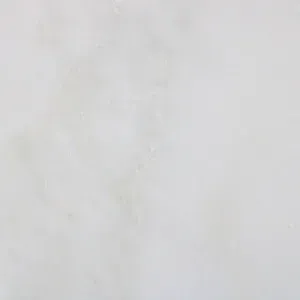 Off-white marble surface with subtle gray and tan veining, creating a neutral, smooth texture.