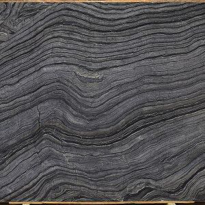 Dark gray marble slab with flowing, layered patterns.