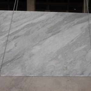 Large, light gray marble slab with subtle veining.