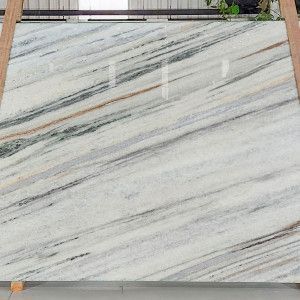 White marble slab with gray, green, and brown veining.