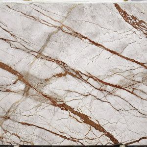 White marble slab with red-brown veining, showcasing a natural stone pattern.