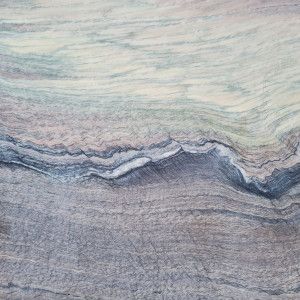 Abstract surface with layered shades of gray, blue, and cream.