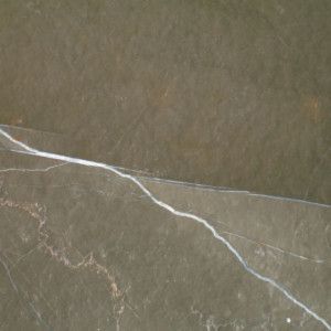 Dark green marble with a white vein.