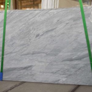 Light gray marble slab with green straps.