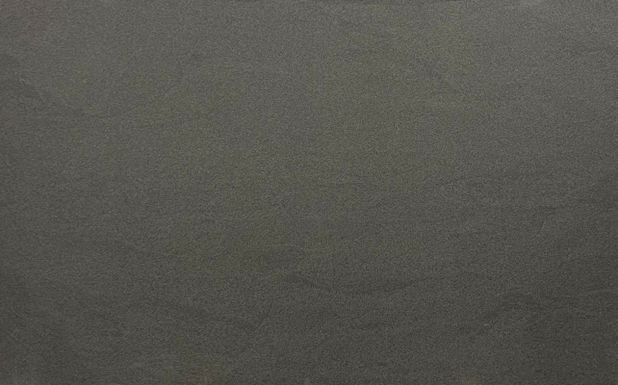 Gray, textured surface, possibly concrete or painted wall.