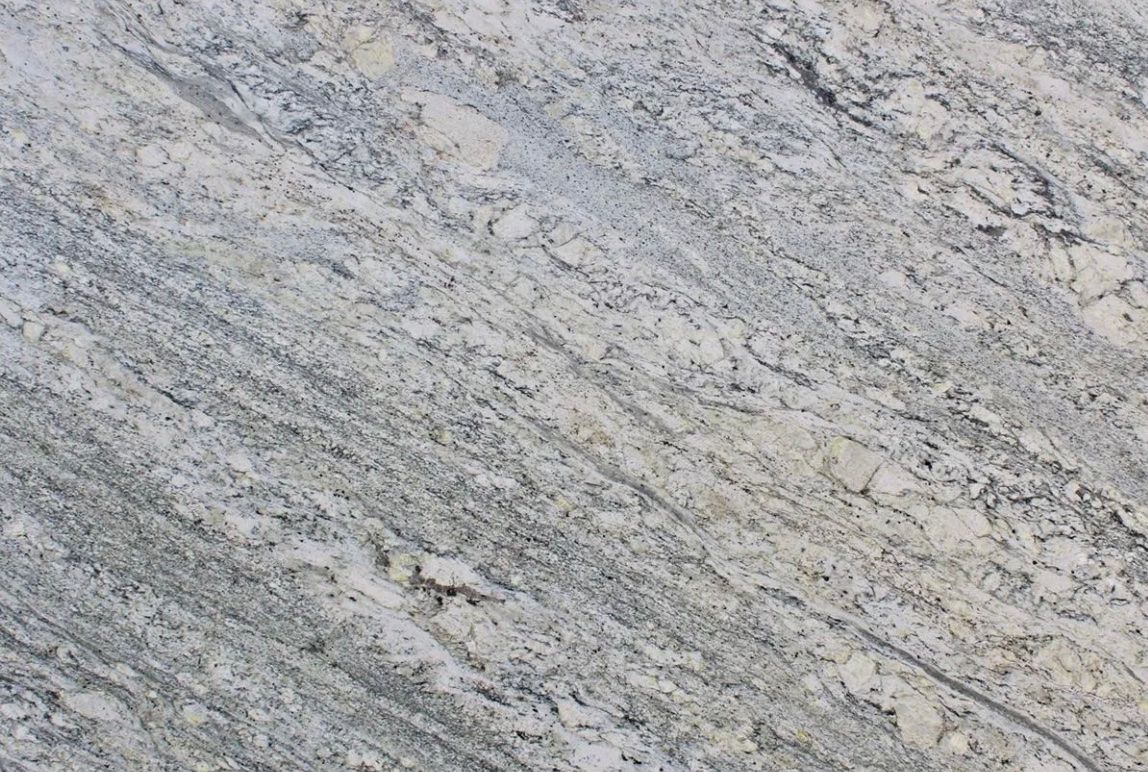 Close-up of a light-colored granite surface with gray and tan veining.