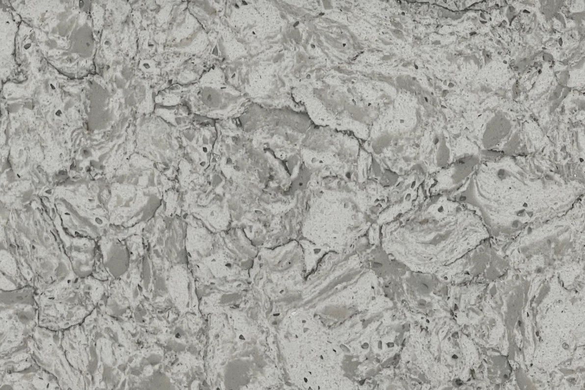 Gray and white quartz countertop with veining and textured surface.
