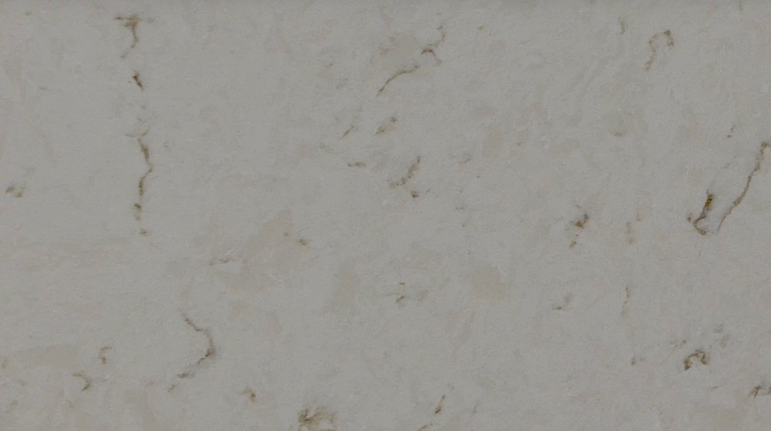 Light gray stone surface with subtle gold veining.