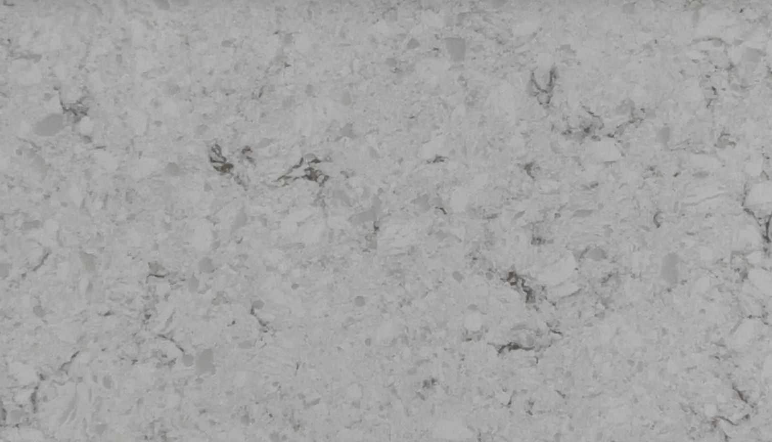 Gray-white countertop with subtle speckled patterns and dark veining.