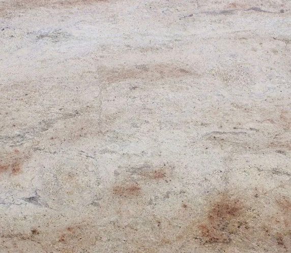 Beige and brown mottled stone surface.