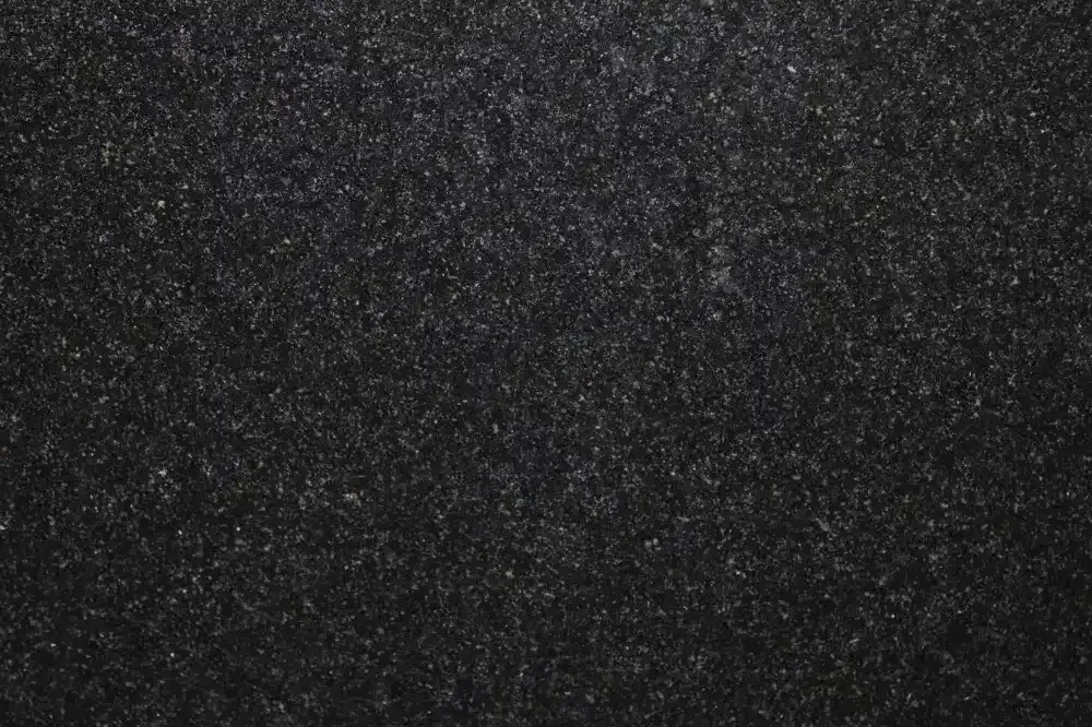 Black granite surface with speckled gray and white flecks.