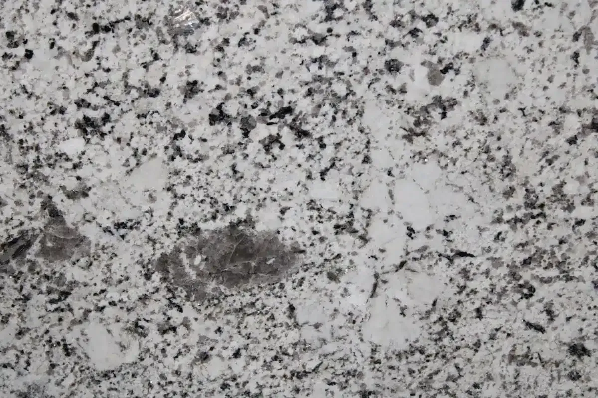White granite countertop with speckled black and gray patterns.