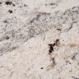 Close-up of white and gray granite countertop with speckled and flowing patterns.