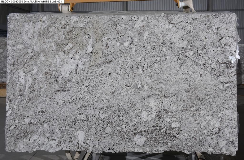 Large, rectangular slab of white and gray granite with speckled patterns, likely for countertops.