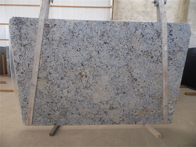 Large gray granite slab supported by wooden frame.