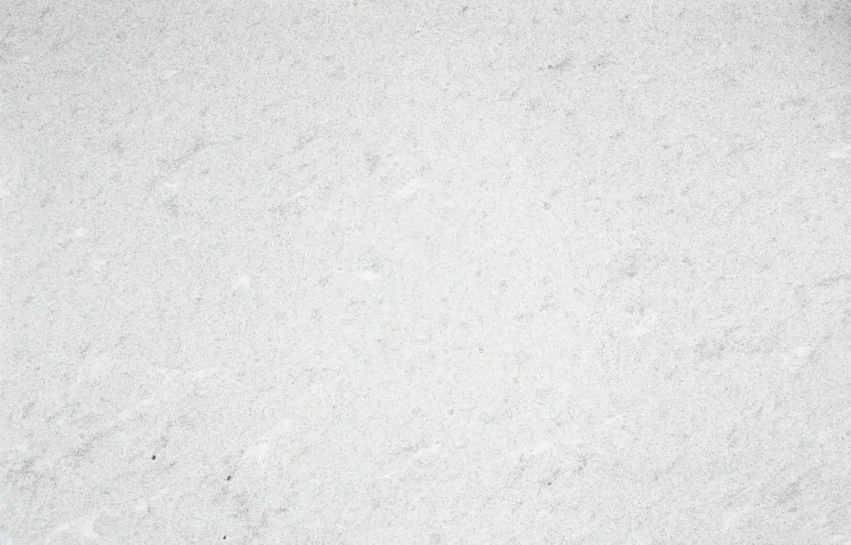 White textured background with subtle variations in tone.