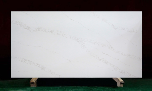 White quartz slab with subtle veining, displayed on wooden supports.