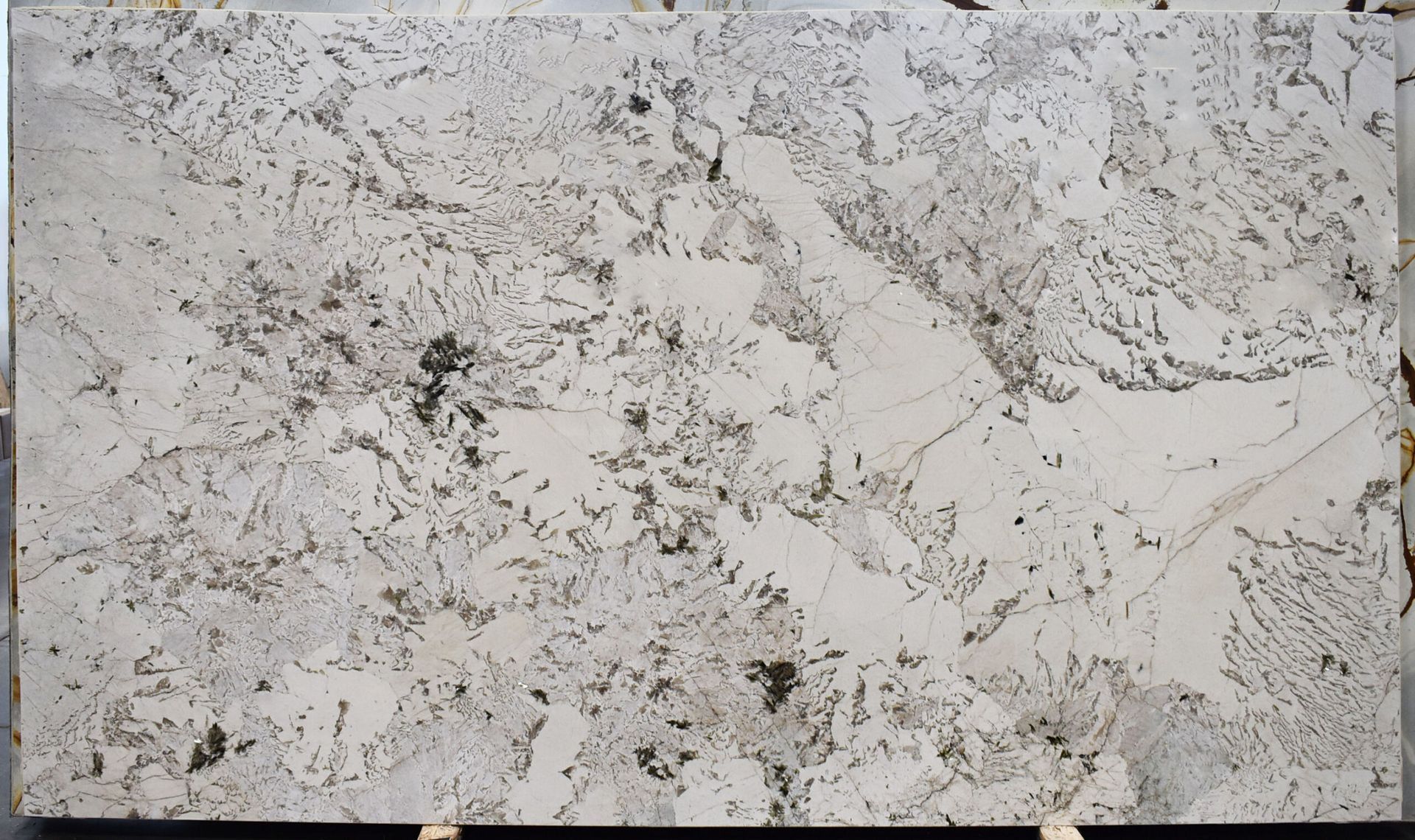 White granite slab with black and gray veining and speckling.