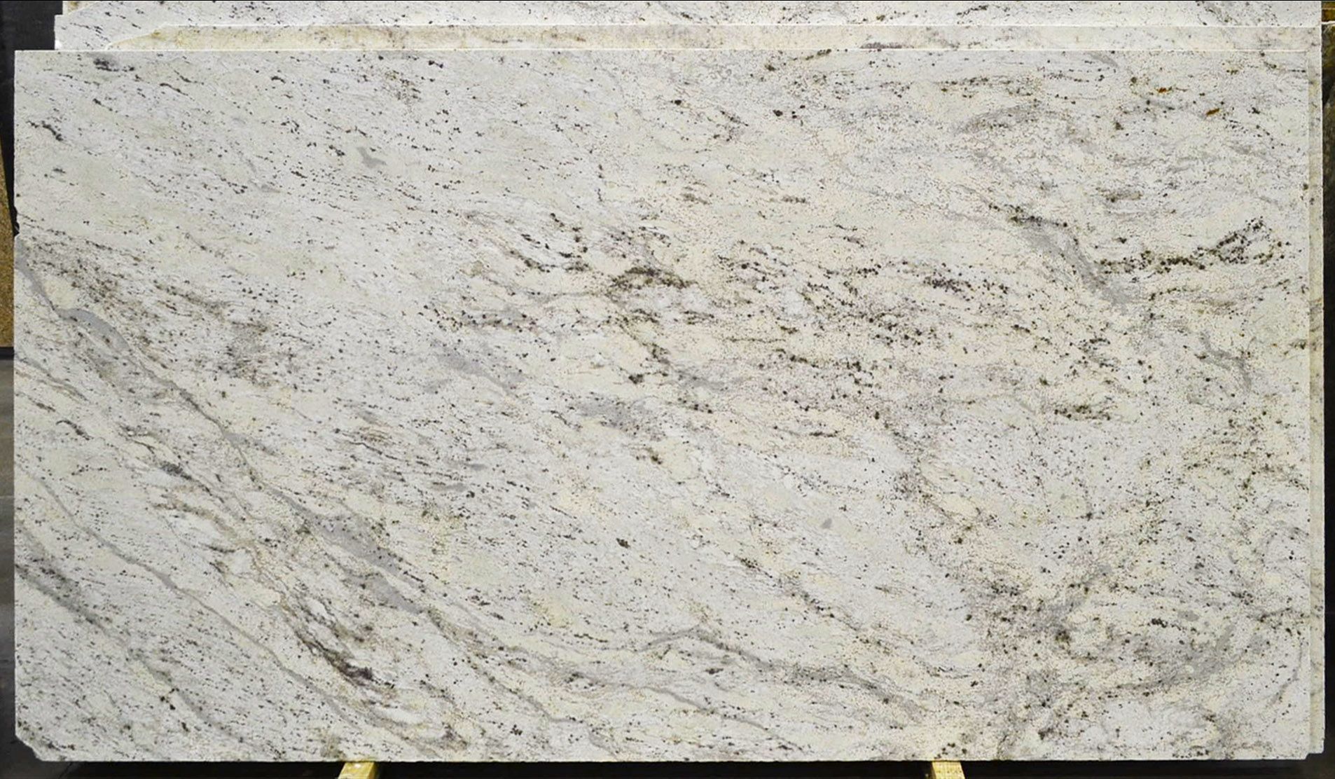 White granite slab with gray and black veining and speckles.