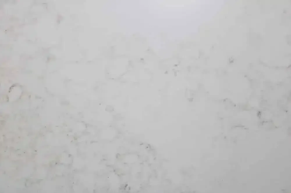 White marble countertop with subtle grey and beige veining.