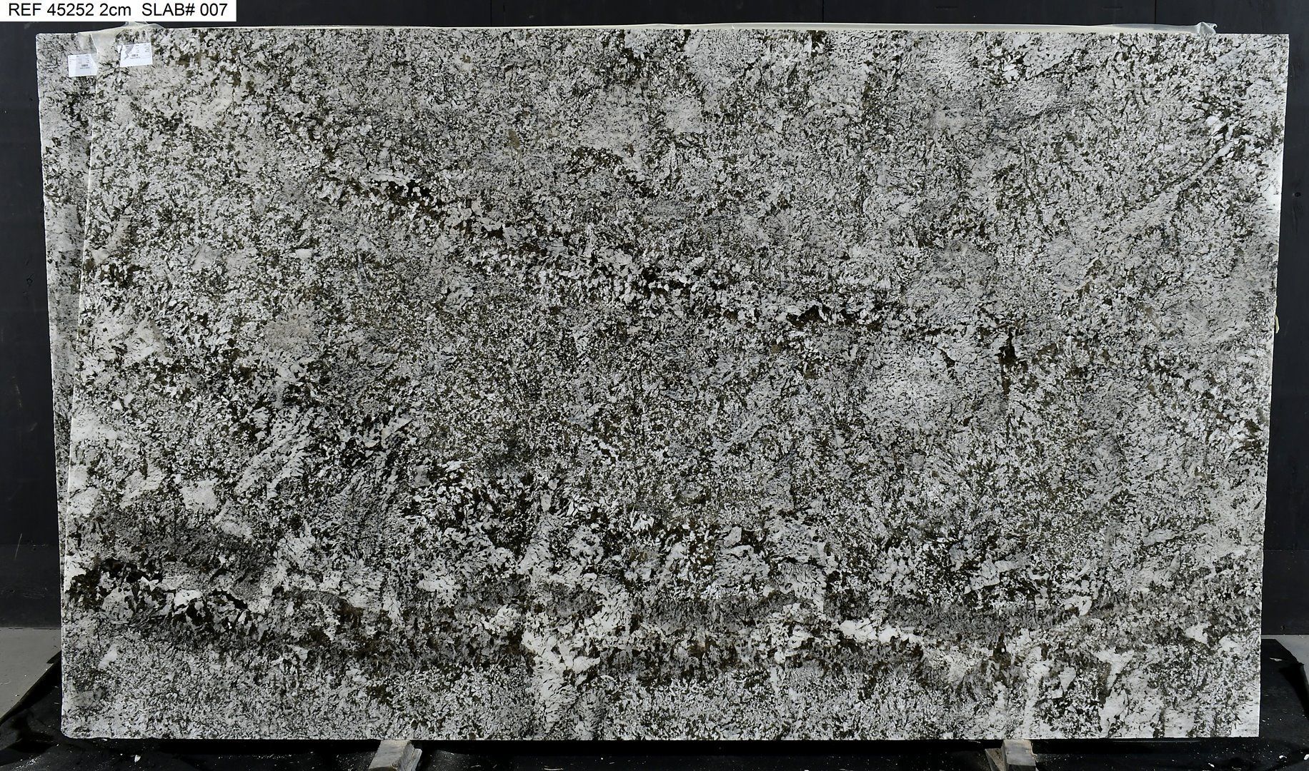 Gray and black granite slab with textured surface.