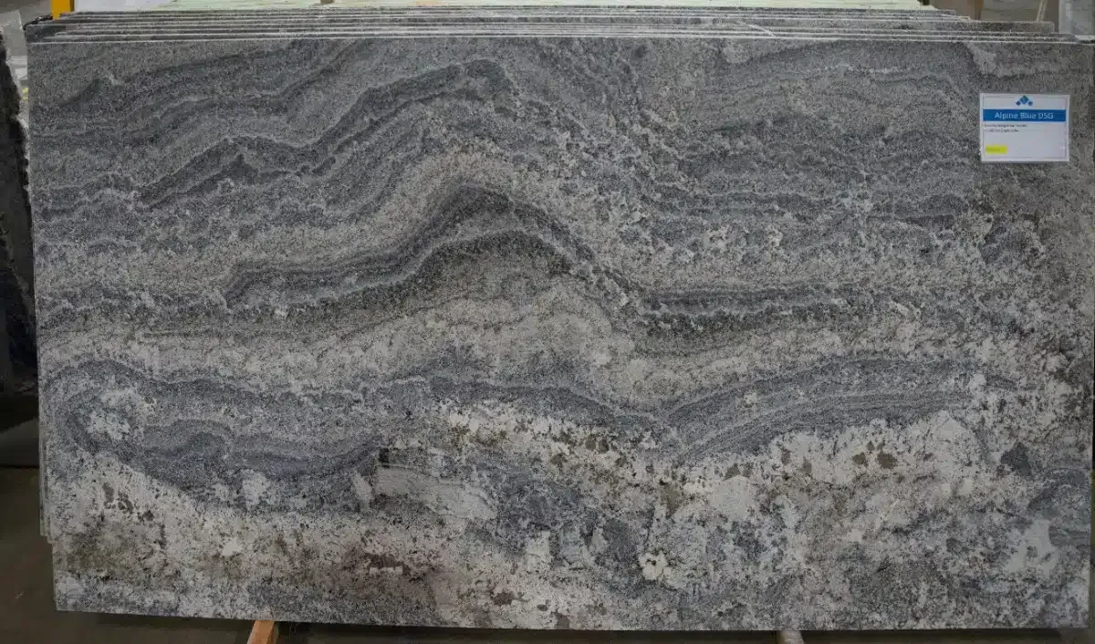 Granite slab with gray, white, and black wave-like patterns.