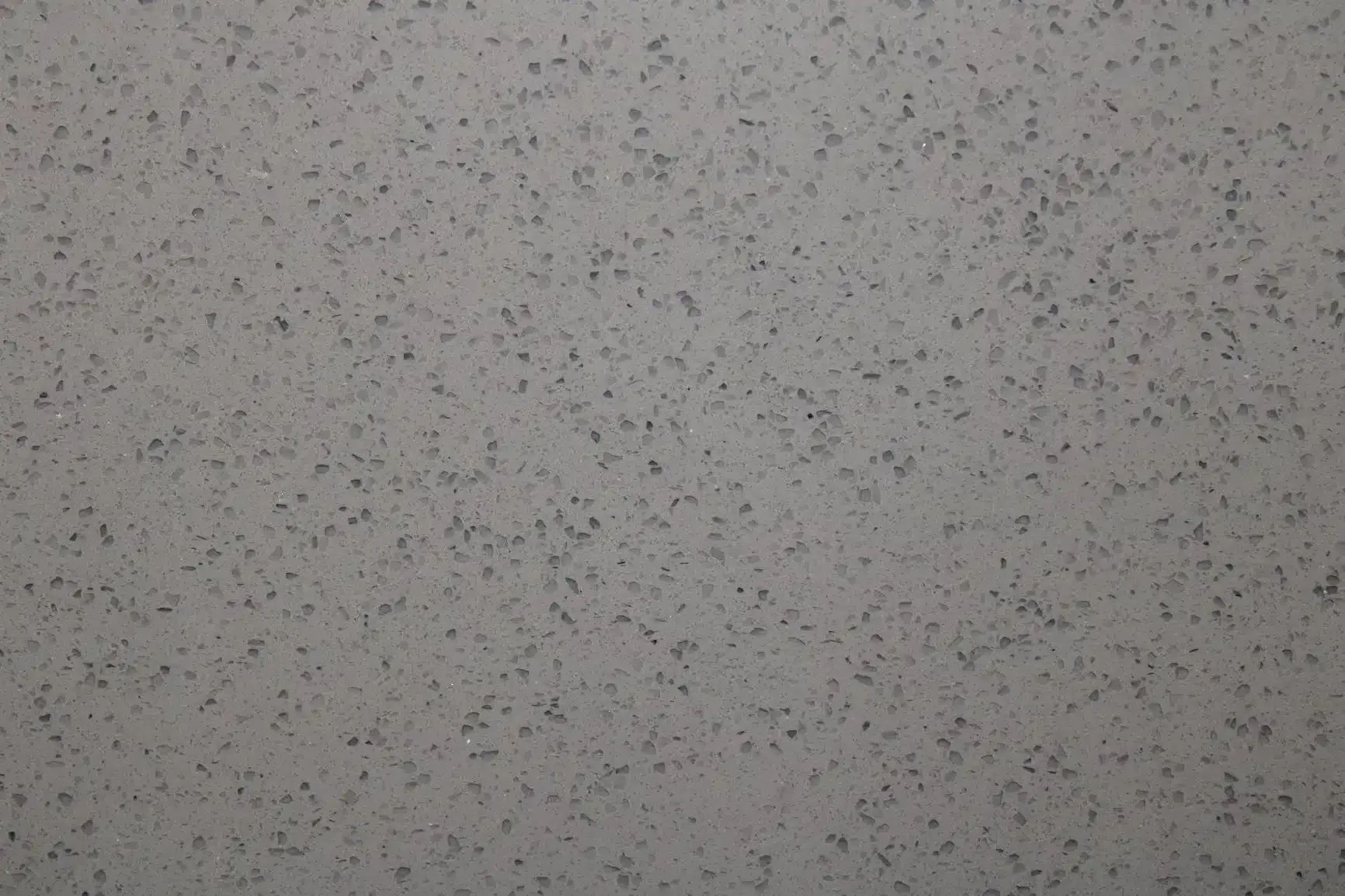 Gray quartz countertop with speckled texture.
