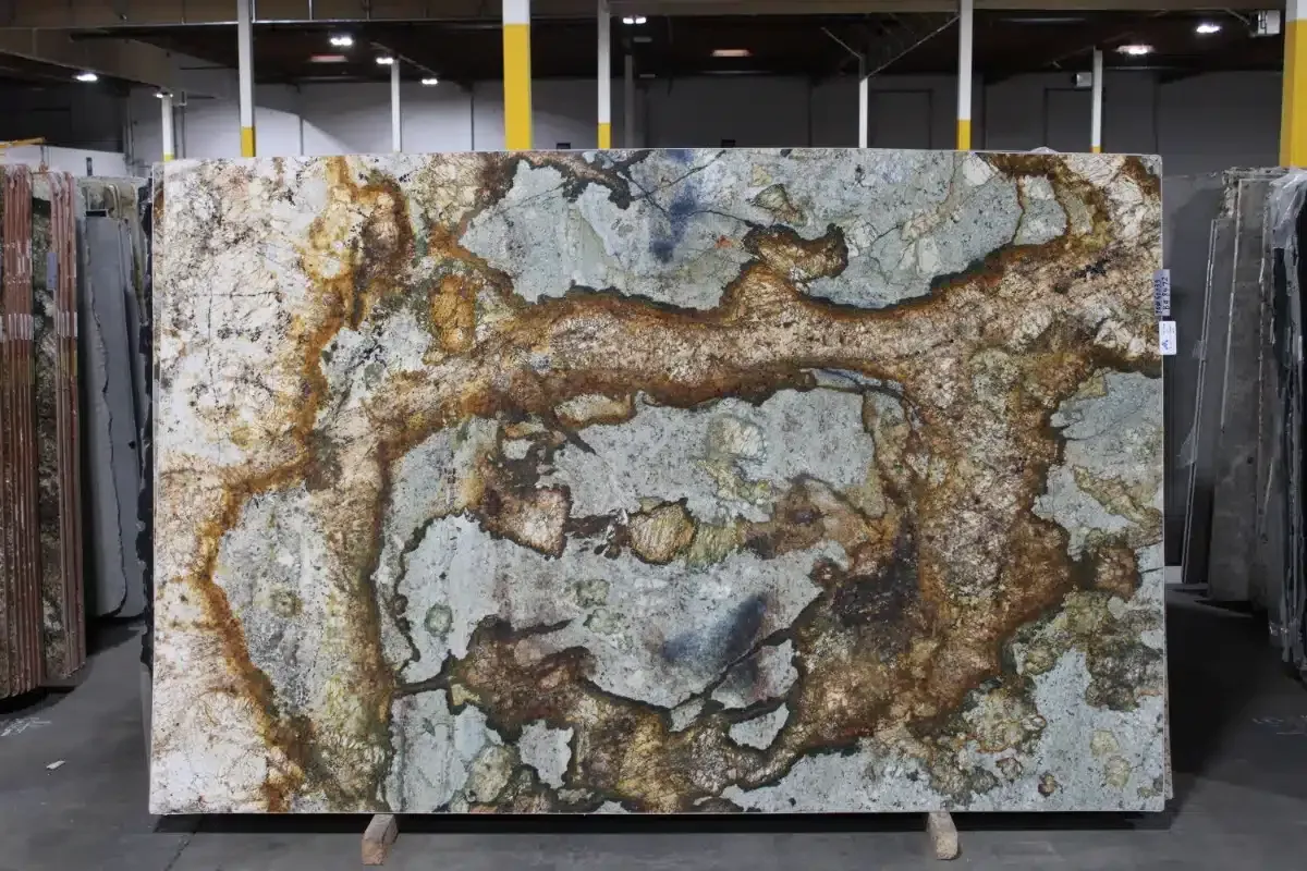 Large slab of granite with swirling patterns in brown, gold, and gray tones.