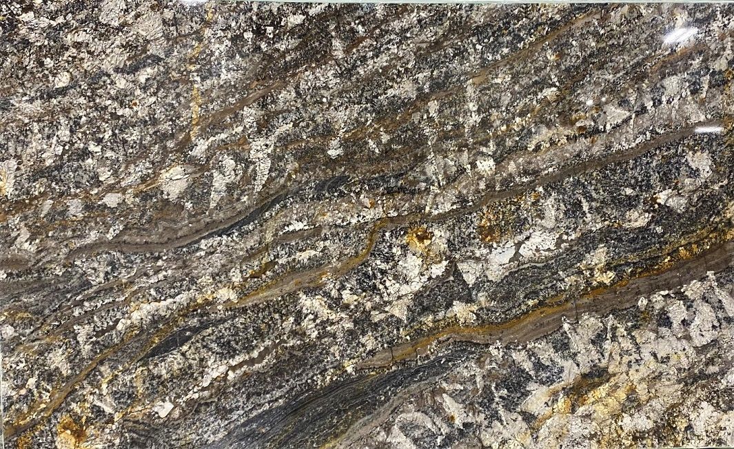 Granite slab with layered gray, brown, and gold patterns, resembling flowing riverbeds.