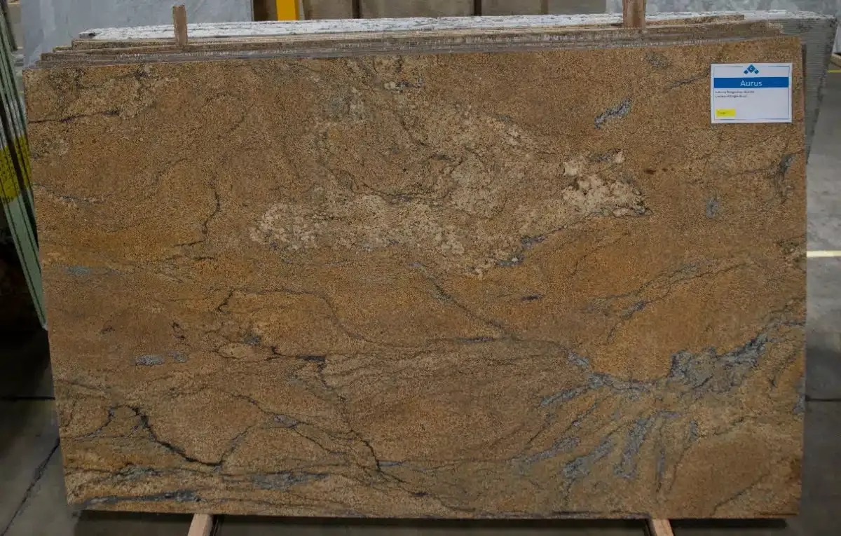 Gold granite slab with brown, tan, and blue veining.