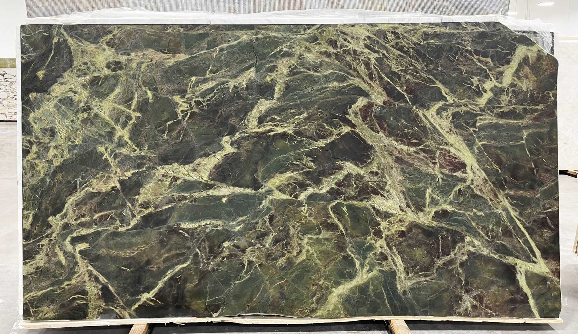 Large slab of green and gold veined marble.