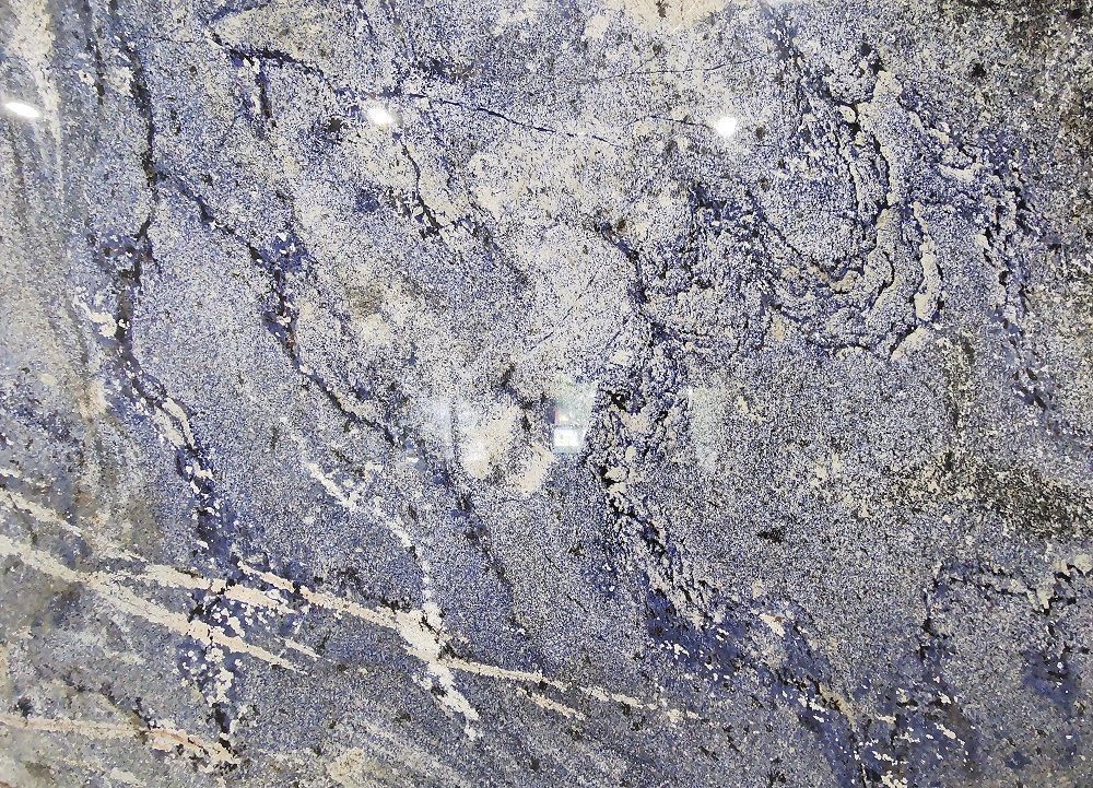 Blue and gray granite countertop with white veining.