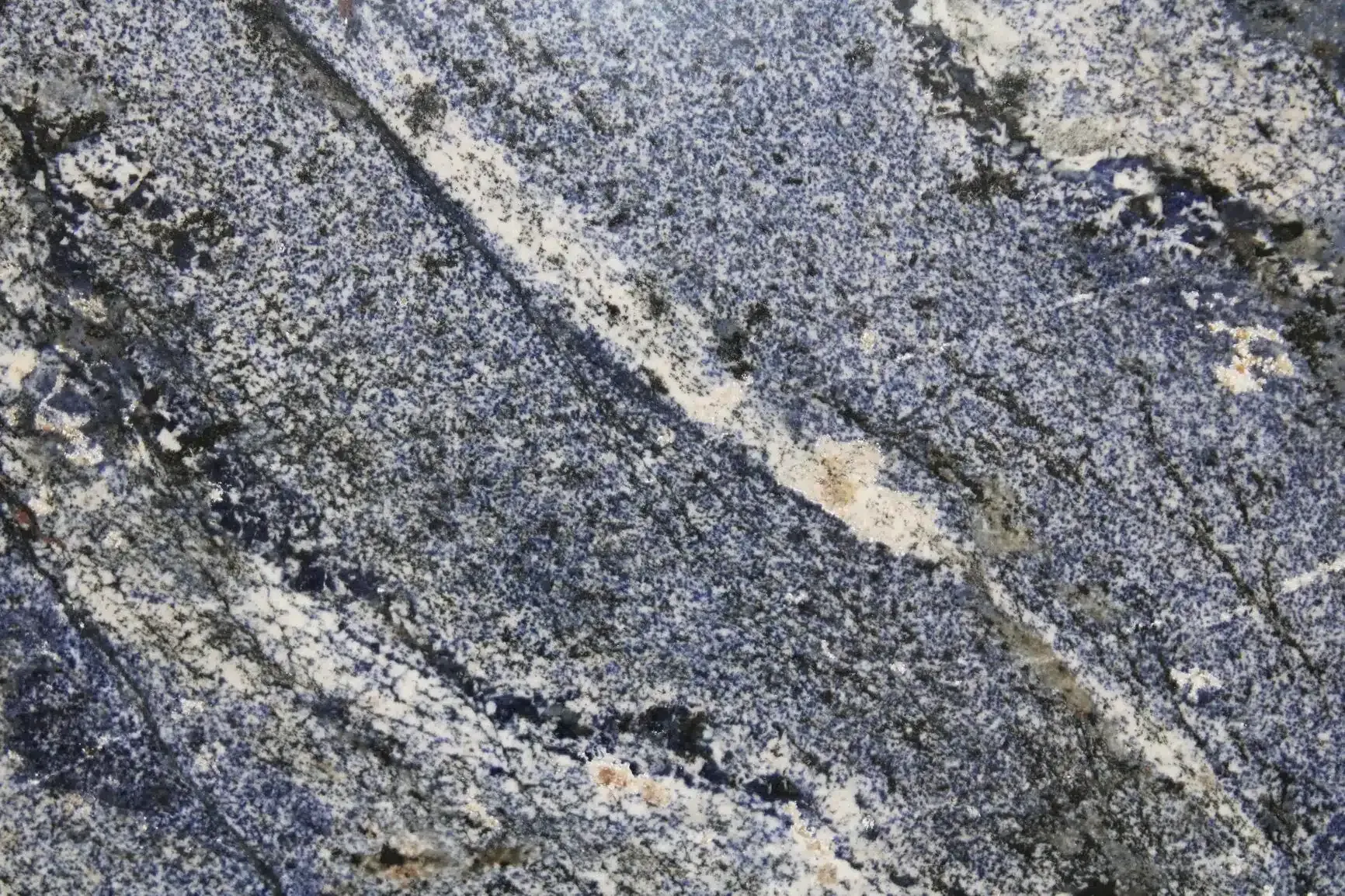 Dark blue and white granite stone with diagonal veins and speckled texture.