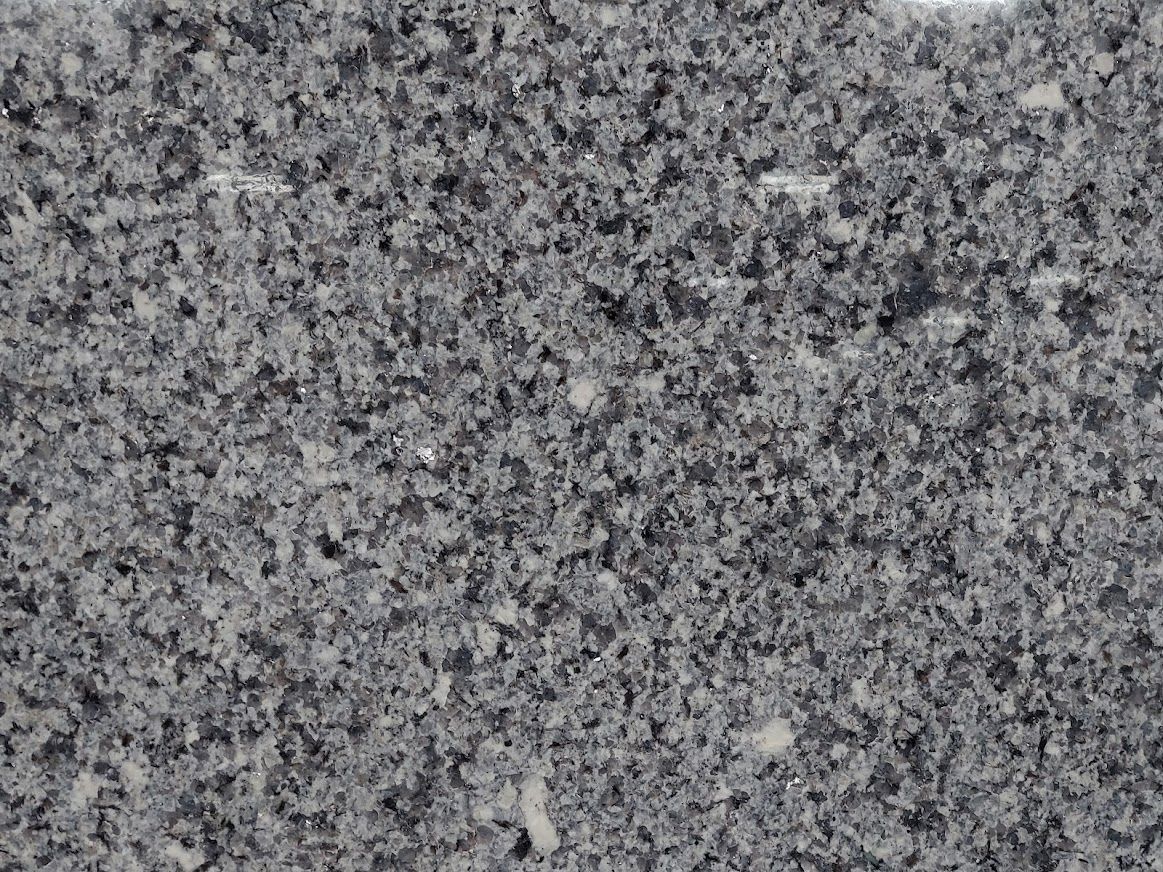 Gray granite surface, showing a mottled texture of light and dark specks.