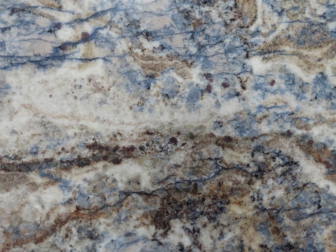 Close-up of a stone surface with blue, brown, and white swirls.