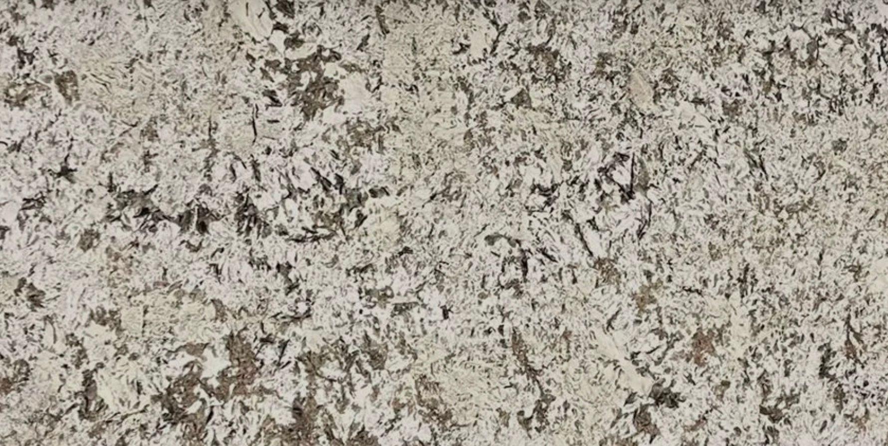 Off-white speckled surface with dark gray and brown patches.