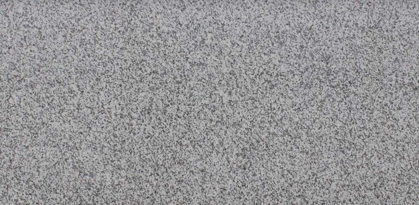 Close-up of gray speckled surface, possibly granite or a similar material.