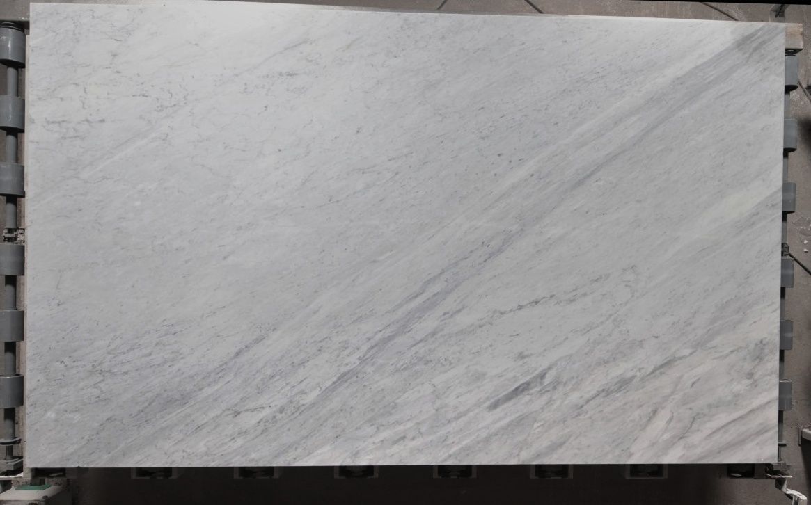 Light gray granite slab with subtle veining, resting on a metal frame.