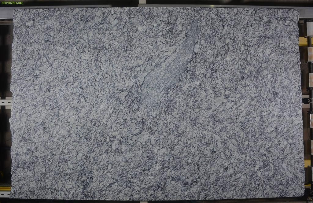 Granite slab with a speckled, grey and white pattern.
