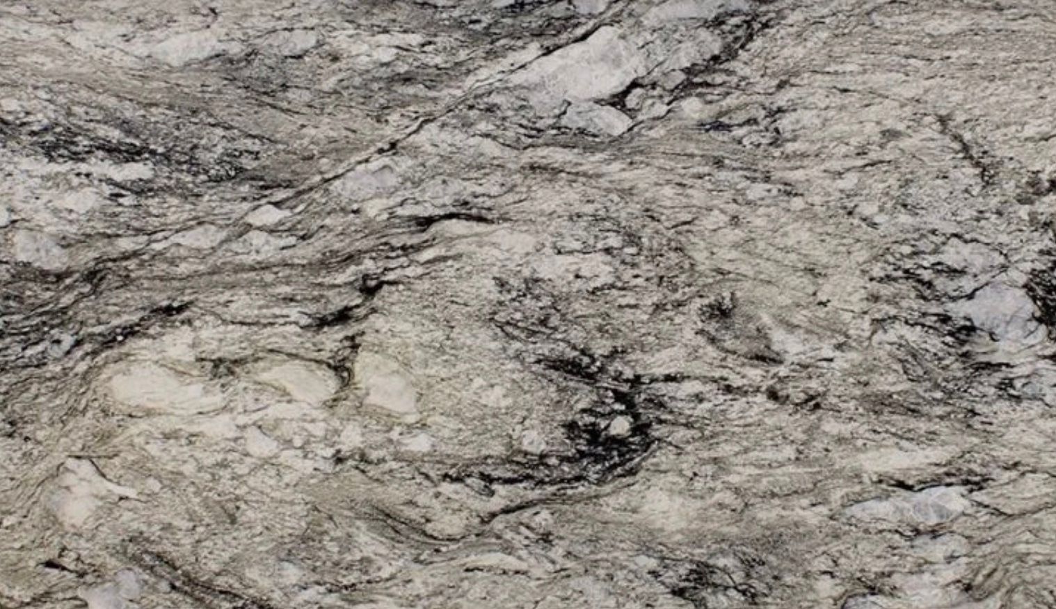 Close-up of a granite countertop with swirling gray, black, and white patterns.