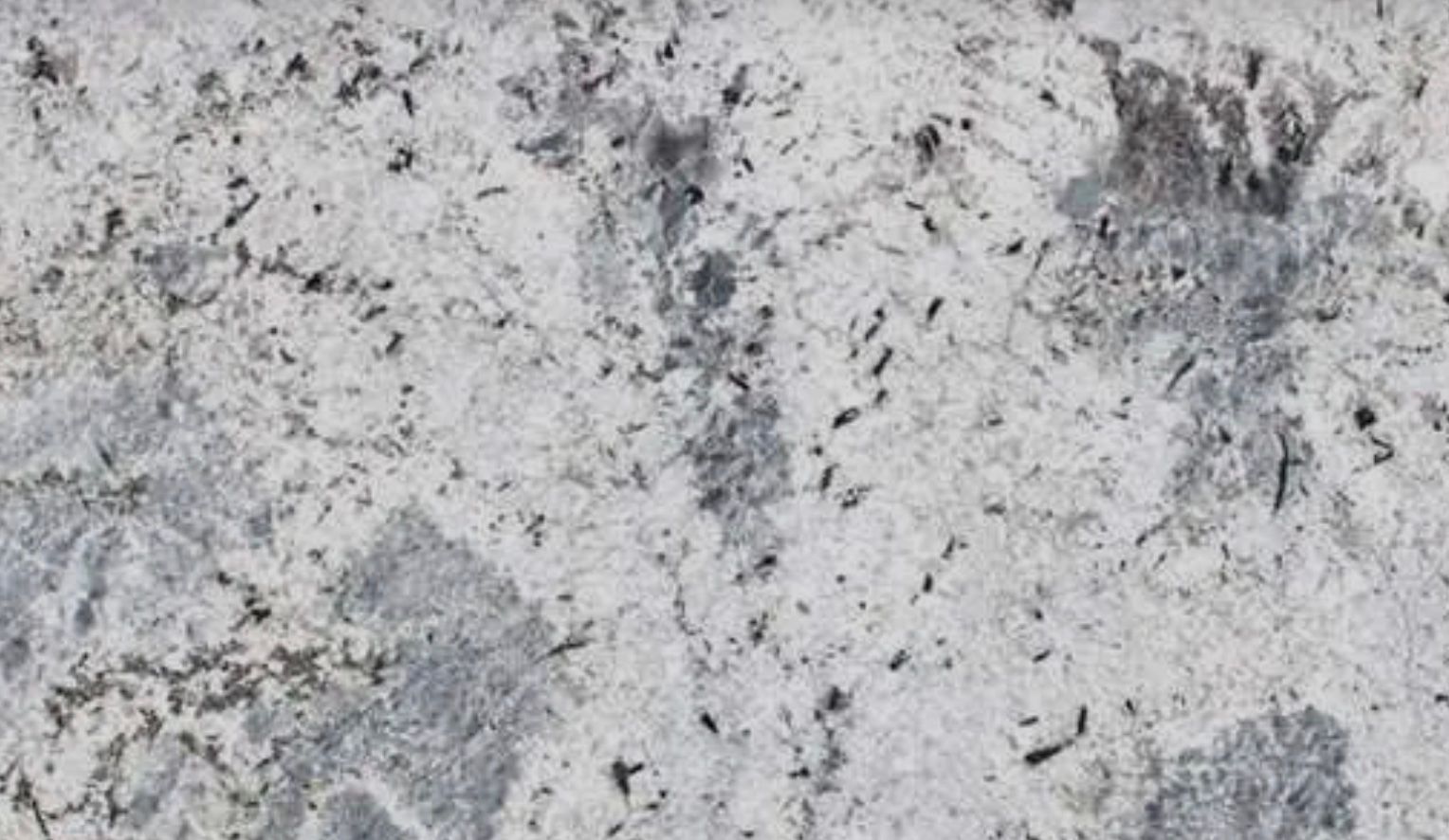 White granite countertop with gray and black speckles.