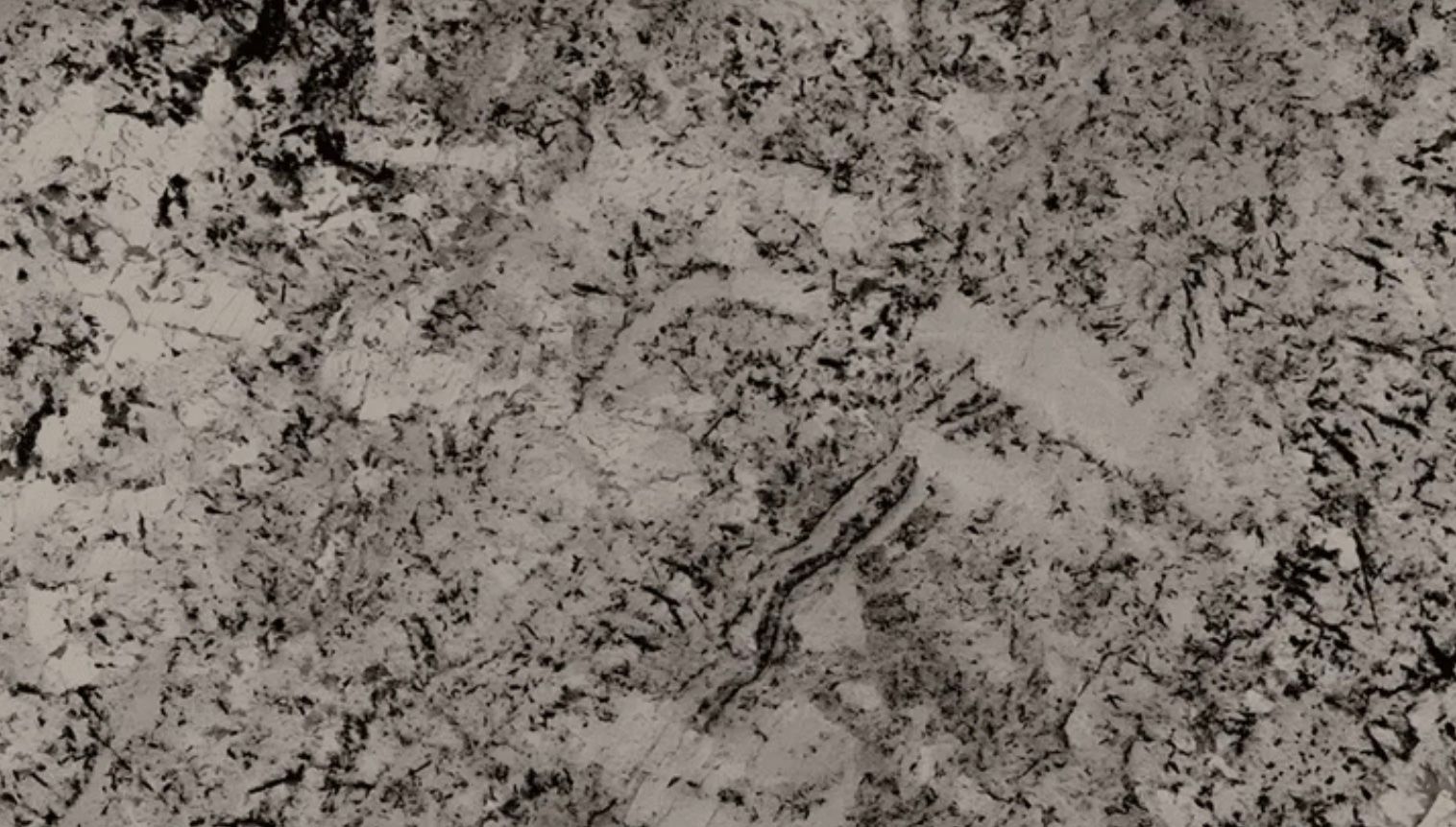 Textured surface with speckled gray and black patterns.