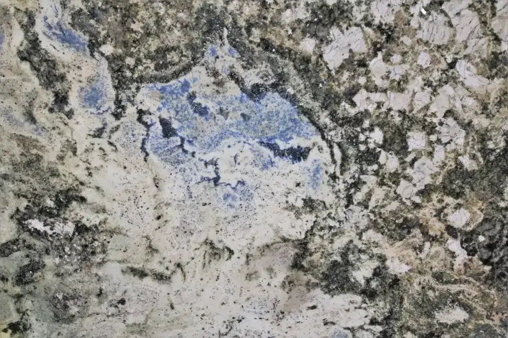 Close-up of granite countertop with blue, beige, and black swirling patterns.