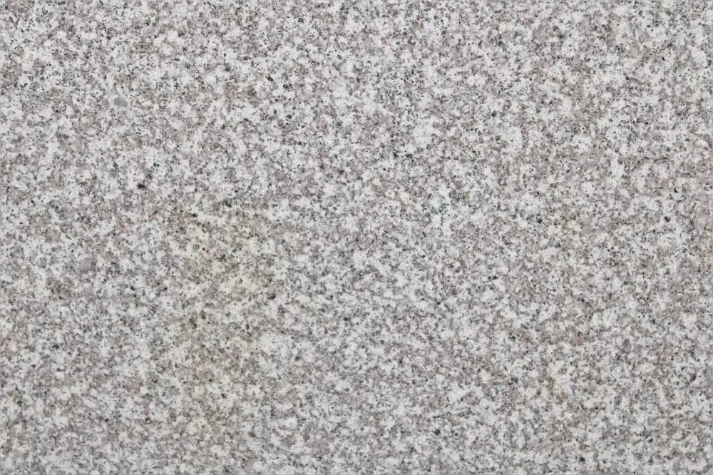 Granite texture in shades of gray, white, and black speckles.