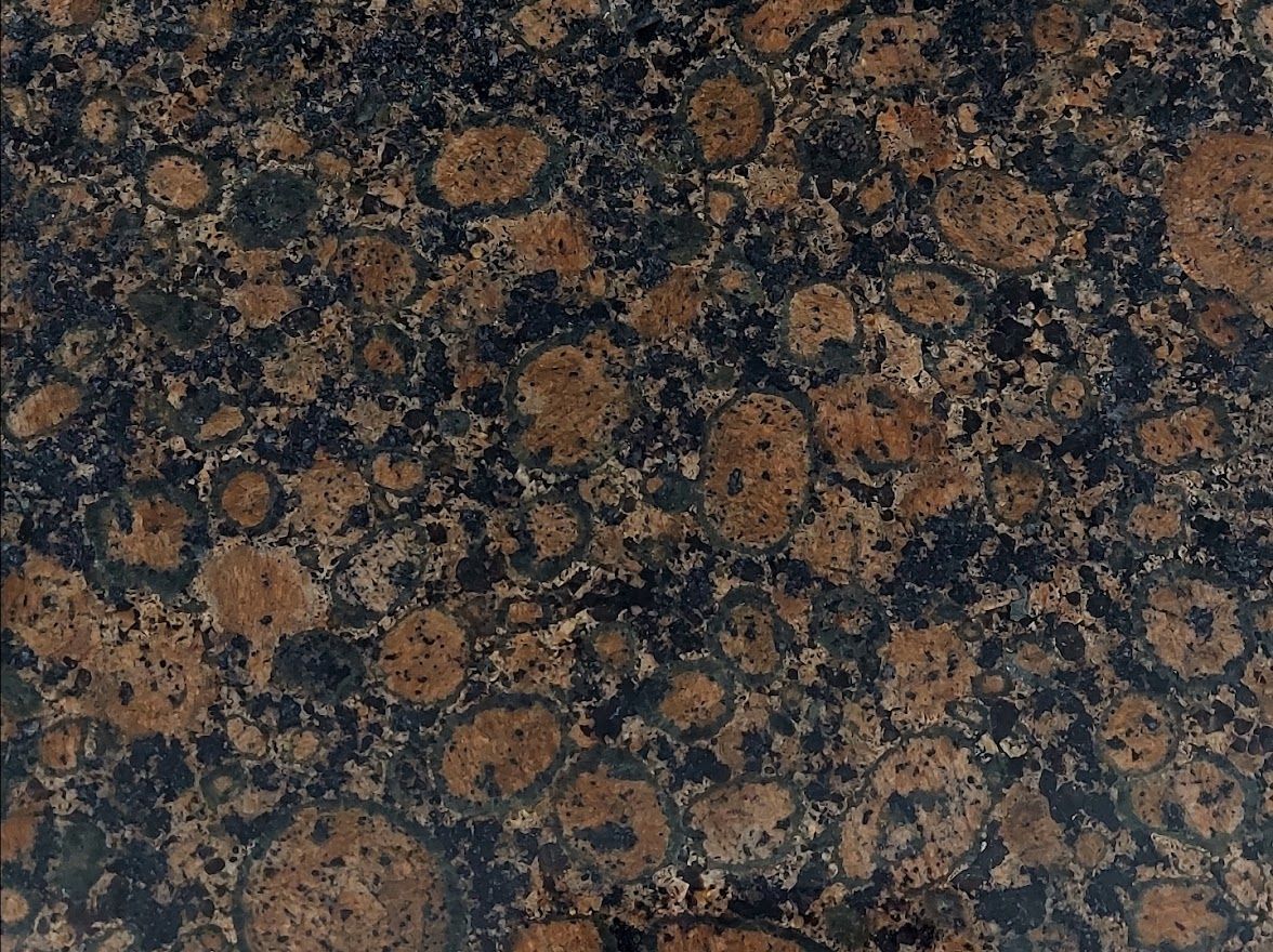 Dark brown granite countertop with circular patterns and black flecks.