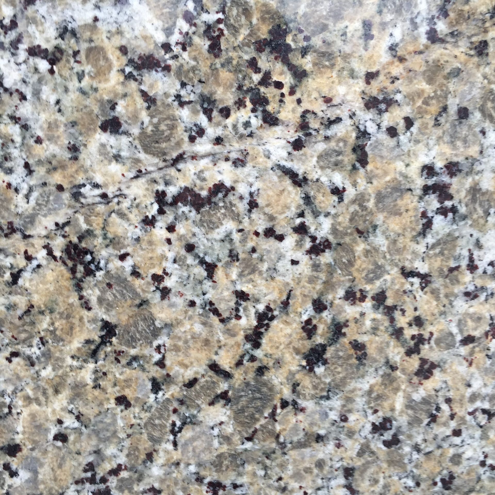 Granite countertop with brown, black, and white speckled patterns.
