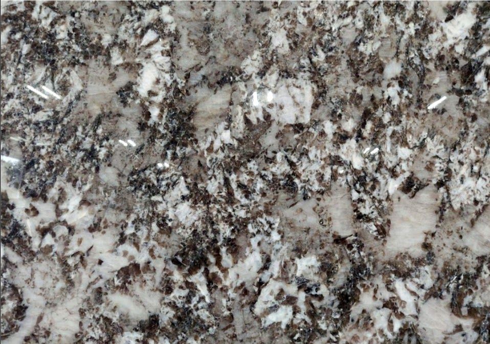 Close-up of a granite countertop with speckled white, gray, and brown patterns.